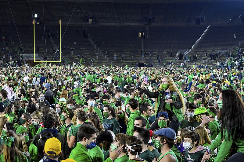 Fans storm the field Saturday night after Notre Dame defeatedClemson 47-40 in two overtimes in South Bend, Ind.