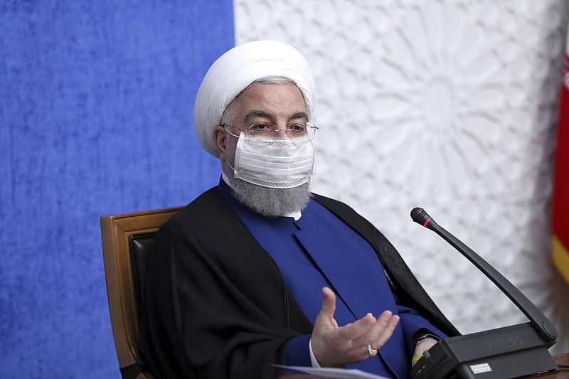 In this photo released by the official website of the office of the Iranian Presidency, President Hassan Rouhani speaks in a meeting in Tehran, Iran, Sunday, Nov. 8, 2020. On Sunday, Rouhani called on President-elect Joe Biden to "compensate for past mistakes" and return the U.S. to Tehran's 2015 nuclear deal with world powers. (Iranian Presidency Office via AP)