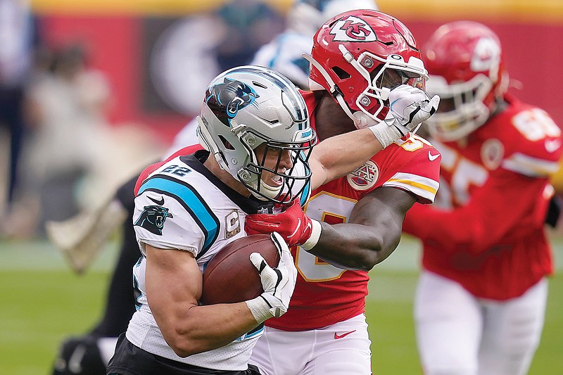 Panthers running back Christian McCaffrey battles against the tackle attempt of Chiefs linebacker Willie Gay Jr. during the first half of Sunday afternoon's game at Arrowhead Stadium.