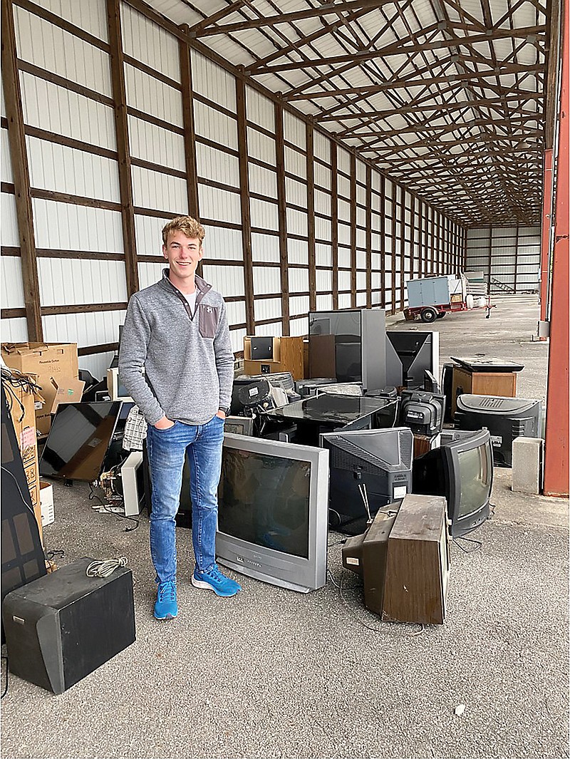 Local Eagle Scout Logan Mathews stands among some of the tube televisions he kept from end up in landfills. Mathews had the help of Boy Scouts Troop 4 and Troop 3004.