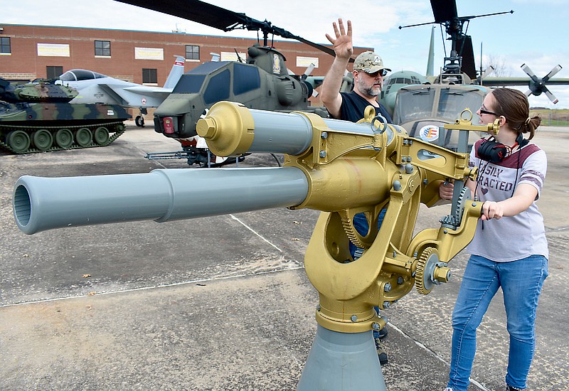 Brandon Easter, left, teaches his daughter Allison about this World War I anti-aircraft gun on Sunday during the sixth annual Military History Appreciation Weekend at the Museum of Military History east of Jefferson City. 