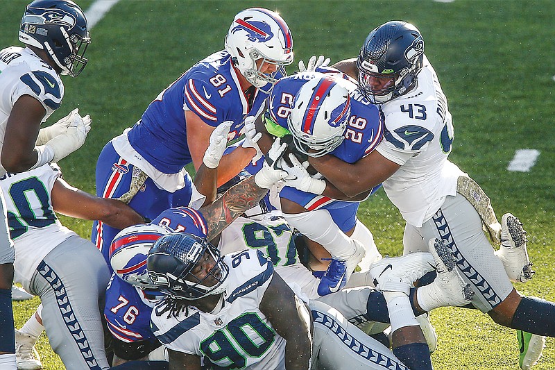 Carlos Dunlap of the Seahawks (43) tackles Bills running back Devin Singletary during the second half of Sunday's game in Orchard Park, N.Y.