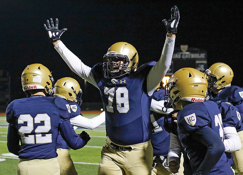 Helias' Grant Boessen cheers as the Crusaders force a turnover in the first quarter of Friday's Class 4 District 6 championship game against Warrensburg at Ray Hentges Stadium.