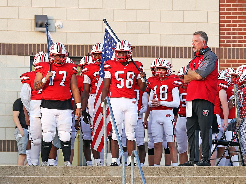 Jefferson City's Baylen Farmer (77) and Fred Wilson (58), along with coach Scott Bailey, get ready to take the field prior to a game this season against Sedalia Smith-Cotton at Adkins Stadium.