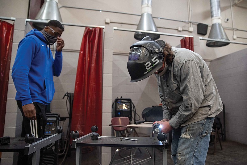 Michael Riley and Christopher Stewart, juniors in Liberty-Eylau High School's welding program, work on repairing desks sent over from another L-EISD school. Students leave the program with the skills and ability to get a job in the field right out of high school.