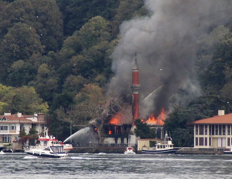 A fire engulfs Vanikoy Mosque, a historic wooden mosque, in Istanbul, Sunday, Nov. 15, 2020. The Vanikoy Mosque, built in the 17th century during the reign of Ottoman Sultan IV Mehmed, is located on the Asian side of Istanbul along the Bosporus Strait. Turkish firefighters were trying to put out the blaze from both land and sea. (DHA via AP)