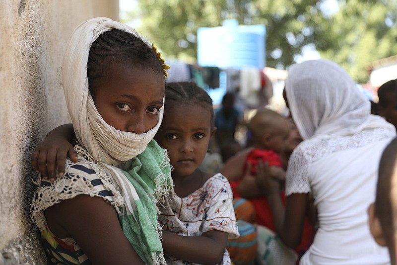 Refugees from the Tigray region of Ethiopia region wait to register at the UNCHR center at Hamdayet, Sudan on Saturday, Nov. 14, 2020.  Ethiopia’s defiant Tigray regional government has fired rockets at two airports in the neighboring Amhara region as a deadly conflict threatens to spread into other parts of Africa’s second-most populous country.   (AP Photo/Marwan Ali)