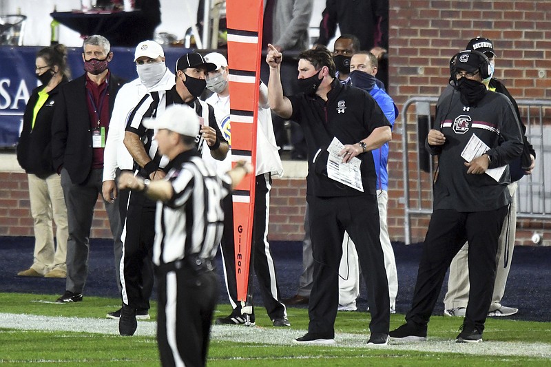 South Carolina coach Will Muschamp talks to an official during Saturday night's game against Mississippi i in Oxford, Miss. Mississippi won 59-42.
