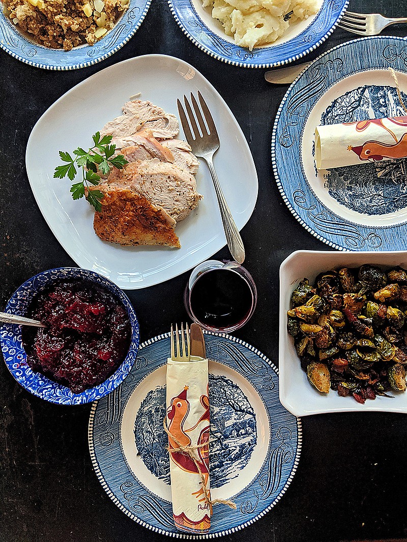 A Thanksgiving table set for two with all the traditional holiday dishes, including roast turkey. (Gretchen McKay/Pittsburgh Post-Gazette/TNS) 