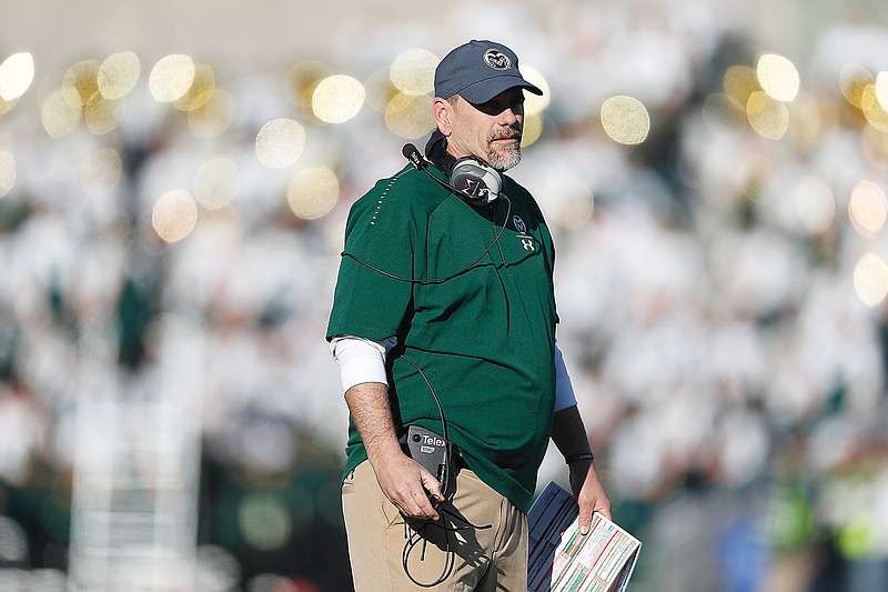 In this Nov 2, 2019, file photo, Mike Bobo watches a Colorado State game in Fort Collins, Colo. Bobo, who was fired after the season at Colorado State, has been named the interim coach at South Carolina.