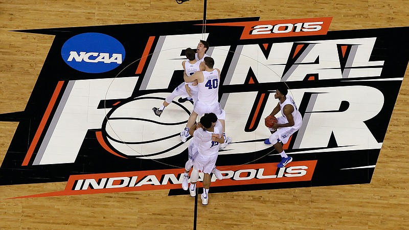 FILE - Duke players celebrate after the NCAA Final Four college basketball tournament championship game against Wisconsin in Indianapolis, in this Monday, April 6, 2015, file photo. The NCAA announced Monday, Nov. 16, 2020, it plans to hold the entire 2021 men's college basketball tournament in one geographic location to mitigate the risks of COVID-19 and is in talks with Indianapolis to be the host city (AP Photo/David J. Phillip, File)