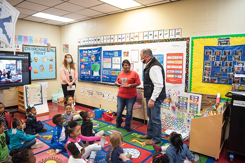 Ashley Bradley, a teacher at Liberty-Eylau Early Childhood Center, and her aide, Shauna Lane, receive information about the bonus check that Liberty-Eylau is giving all of its staff. Teachers across all campuses were visited Tuesday morning by members of the L-EISD administration and school board to be given the good news.