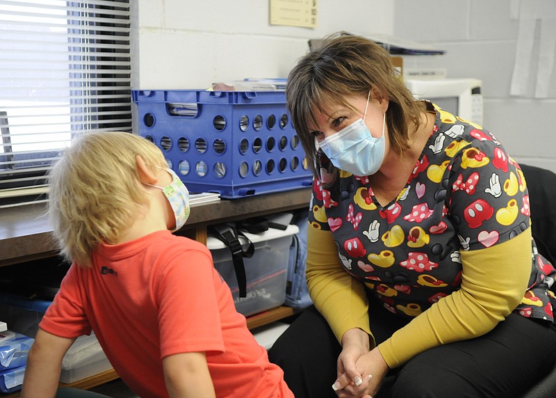 Donna Robinson, North Elementary School's nurse, interacts with Caleb Wegener, a student at the school.