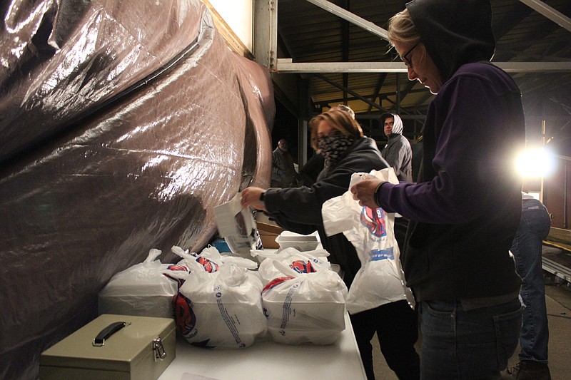 <p>Democrat photo/Austin Hornbostel</p><p>Volunteers help to bag steak dinners to go for drive-thru customers at the Moniteau County Fairgrounds. Usually the site of an in-person dinner and scholarship fundraiser hosted by the Moniteau County Cattlemen’s Association, this year’s dinner shifted to a drive-thru format due to the continuing effects of the coronavirus pandemic. This year’s iteration resulted in $1,766 raised for scholarships for Moniteau County students and 284 meals served.</p>