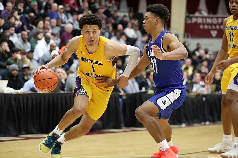 In this Jan. 19, 2020, file photo, then-Montverde Academy's Cade Cunningham (1) drives against an unidentified IMG Academy defender during a high school basketball game at the Hoophall Classic in Springfield, Mass. Oklahoma State could have a year to remember, even if it doesn't end in the NCAA Tournament. Freshman point guard Cade Cunningham, a preseason Associated Press All-American, stayed at Oklahoma State despite the NCAA banning the Cowboys from postseason play this season. (AP Photo/Gregory Payan, File)
