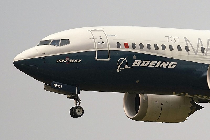 FILE - In this Sept. 30, 2020, file photo, a Boeing 737 Max jet, piloted by Federal Aviation Administration Chief Steve Dickson, prepares to land at Boeing Field following a test flight in Seattle. The FAA is poised to clear the Boeing 737 Max to fly again after grounding the jets for nearly two years due to a pair of disastrous crashes that killed 346 people. (AP Photo/Elaine Thompson, File)