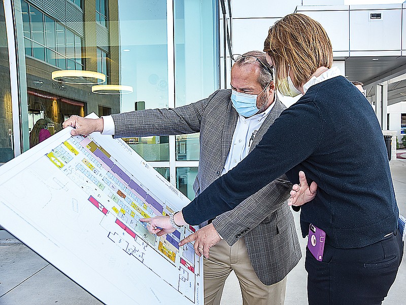 Adrienne Mills, right, director of surgical services, looks over architectural plans Wednesday with Martin Grabanski, director of facilities at Capital Region Medical Center. CRMC announced the addition of a $20 million, state-of-the-art outpatient surgical center.