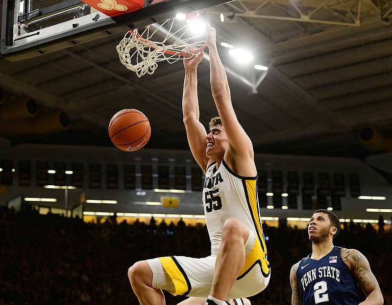 Iowa's Luka Garza (55) dunks the ball as Penn State's Myles Dread (2) looks on during the second half of an NCAA college basketball game in Iowa City, Iowa, in this Feb. 29, 2020, file photo. Garza could have heard his name called in Wednesday night's NBA draft. He instead opted for the uncertainty of playing a final college basketball season amid a pandemic. (AP Photo/Cliff Jette, File)