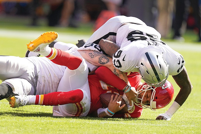 Chiefs quarterback Patrick Mahomes is sacked by Raiders defensive ends Maxx Crosby (rear) and Arden Key during a game last month at Arrowhead Stadium.