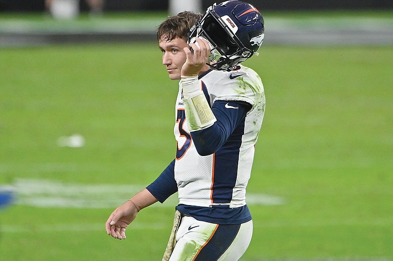 Broncos quarterback Drew Lock takes off his helmet after a play in last Sunday's game against the Raiders in Las Vegas.