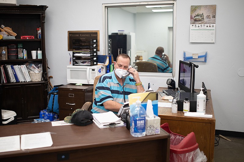 Michael Hafner answers a call at the front desk of Randy Sams Outreach Center. Hafner is a former client of Randy Sams who was able to use the resources they offer to better himself and find success.