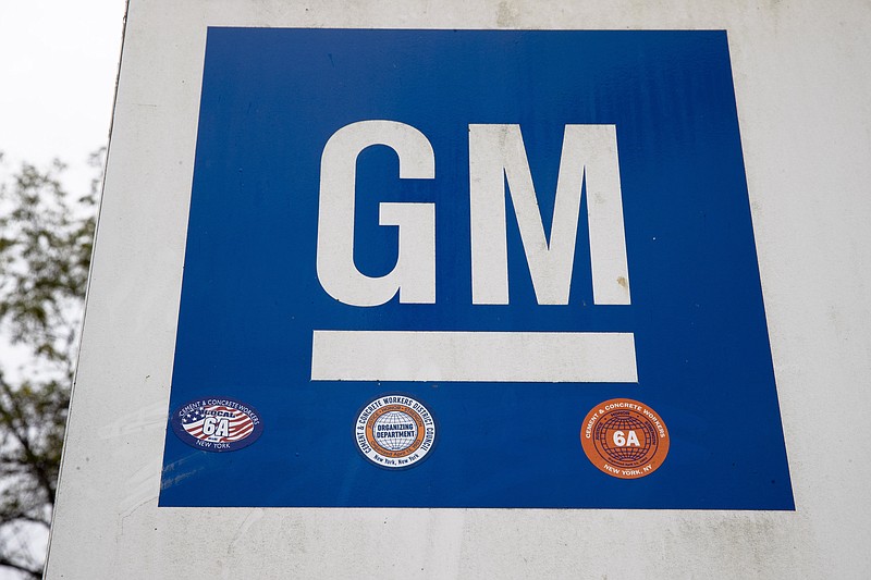 FILE - This Oct. 16, 2019, file photo shows a sign at a General Motors facility in Langhorne, Pa.  On Thursday, Nov. 19, 2020, General Motors says a pending breakthrough in battery chemistry will cut the price of its electric vehicles so they equal those powered by gasoline within five years.  (AP Photo/Matt Rourke, File)