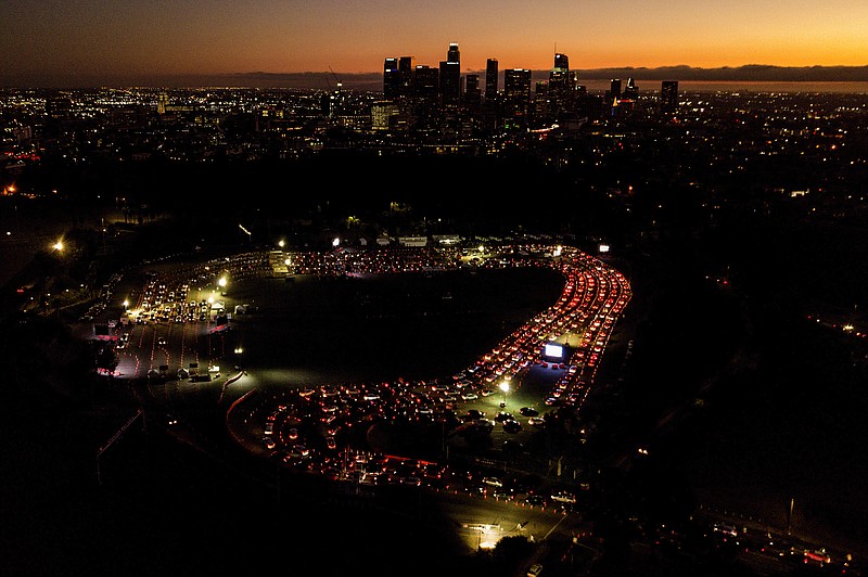 FILE - In this Nov 18, 2020, file photo, motorists wait in long lines to take a coronavirus test in a parking lot at Dodger Stadium in Los Angeles. With coronavirus cases surging and families hoping to gather safely for Thanksgiving, long lines to get tested have reappeared across the U.S. (AP Photo/Ringo H.W. Chiu, File)