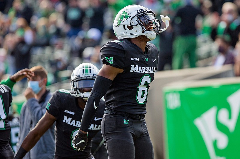 In this Saturday, Nov. 14, 2020, file photo, Marshall's Micah Abraham (6) celebrates after a Middle Tennessee turnover during an NCAA college football game in Huntington, W.Va. An unusual college football season has produced some unexpected unbeaten teams dotting the AP Top 25 with about a month left. Led by No. 7  Cincinnati and No. 8 BYU, five teams from outside the Power Five conferences have yet to lose.  (Sholten Singer/The Herald-Dispatch via AP, File)