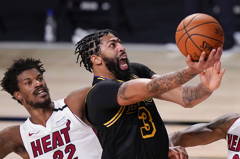 Anthony Davis of the Lakers shoots past Jimmy Butler of the Heat during a game last month in the NBA Finals in Lake Buena Vista, Fla.
