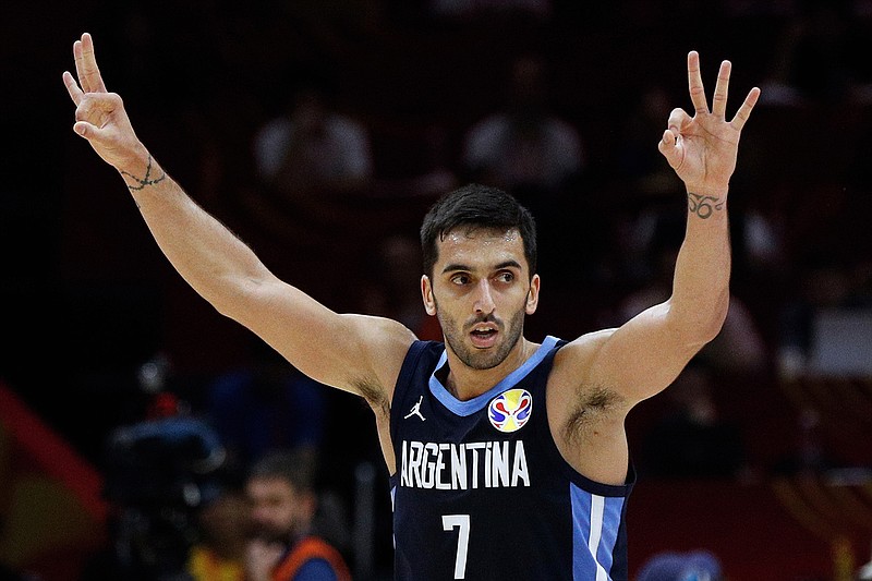 In this Sept. 4, 2019, file photo, Facundo Campazzo of Argentina celebrates after a teammate's 3-pointer against Russia during their Group B match in the FIBA Basketball World Cup at the Wuhan Sport Center in Wuhan in central China's Hubei province. Campazzo agreed to a two-year deal with the Denver Nuggets on Friday, Nov. 20, 2020, the opening day of free agency, according to a person with direct knowledge of the deal. The person spoke to The Associated Press on condition of anonymity because the contract remains unfinished until at least Sunday, when the NBA moratorium on new signings will be lifted. (AP Photo/Andy Wong, File)