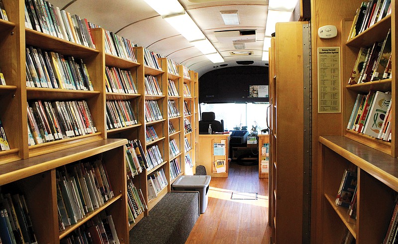 Visitors aren't currently allowed on the bookmobile, but the shelves are still full, with the driver ready to deliver holds.