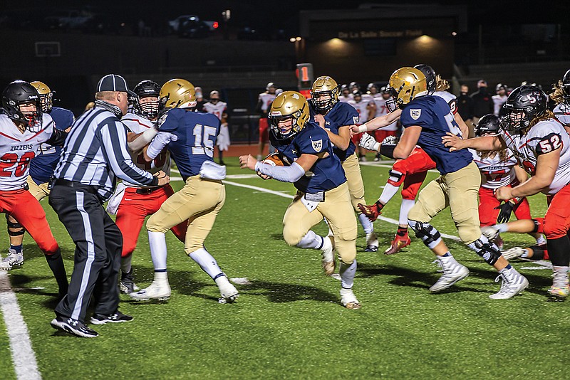 Helias quarterback Jacob Weaver runs for a first down Friday night against West Plains in a Class 4 quarterfinal contest at Ray Hentges Stadium.
