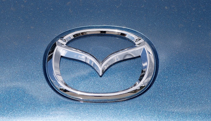 In this June 14, 2020, photograph, a Mazda company logo shines on the front of an unsold 2020 Miata at a Mazda dealership in Littleton, Colo. On Thursday, Nov. 19, Mazda beat traditional winners Lexus and Toyota to win top honors as the most dependable auto brand in Consumer Reports' annual reliability survey.   Reports surveyed organization members who own more than 300,000 vehicles from model years 2000 to 2020.  (AP Photo/David Zalubowski)