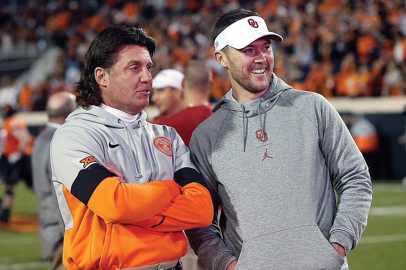 In this Nov. 30, 2019, file photo, Oklahoma State coach Mike Gundy (left) talks with Oklahoma coach Lincoln Riley before Bedlam in Stillwater, Okla.