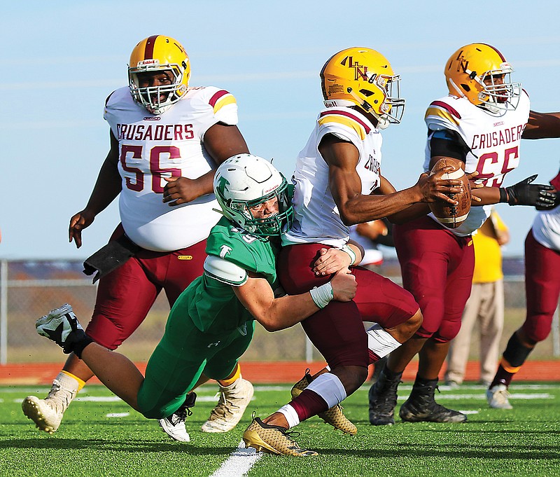 Blair Oaks defensive lineman Rylee Niekamp wraps up Lutheran North quarterback Jordan Smith during a 2018 Class 2 semifinal game at the Falcon Athletic Complex in Wardsville. Blair Oaks will host Lutheran North today in the Class 3 quarterfinals.