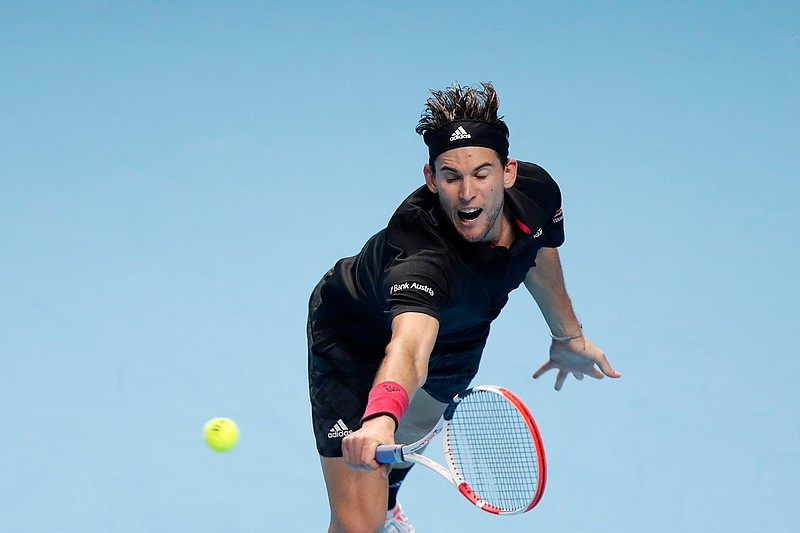 Dominic Thiem of Austria returns the ball to Novak Djokovic of Serbia during their semifinal match at the ATP World Finals tennis tournament at the O2 arena in London, Saturday, Nov. 21, 2020. (AP Photo/Frank Augstein)