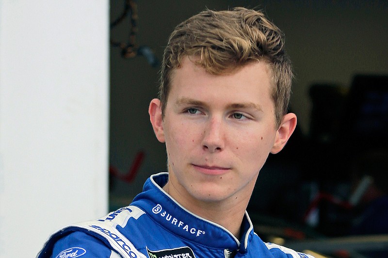 In this July 4, 2019, file photo, Matt Tifft stands outside his garage during practice at the NASCAR auto race at Daytona International Speedway in Daytona Beach, Fla.  NASCAR will have another new team in 2021 — bringing the total to three new ownership groups in the Cup Series —  with the formation of Live Fast Motorsports. The team formally announced Friday, Nov. 20, 2020, is owned by drivers Matt Tifft and B.J. McLeod. (AP Photo/Terry Renna, File)