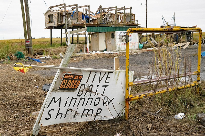 In this Oct. 30, 2020 file photo, a bait shop and neighboring building is seen damaged by Hurricane Zeta in Golden Meadow, La.  Hurricane Zeta left much of lower Terrebonne and lower Lafourche parishes in shambles when it made landfall on Oct. 28.  (AP Photo/Matthew Hinton, File)