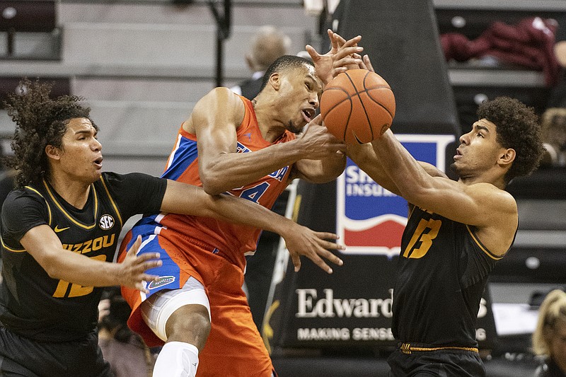 In this Jan. 11 file photo, Florida's Kerry Blackshear Jr. (center) loses control of the ball between Missouri's Mark Smith (right) and Dru Smith (left) during the second half of a game at Mizzou Arena in Columbia.