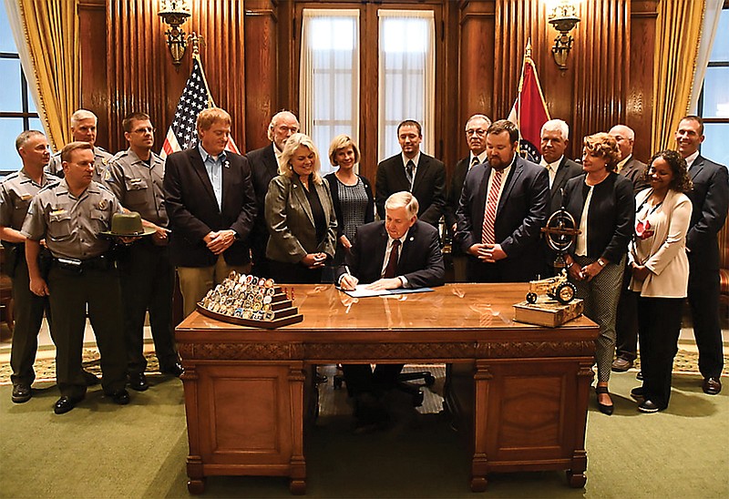 In this July 15, 2019, file photo, Missouri Gov. Mike Parson signs into law a poaching bill that significantly raises fines for those convicted of illegally taking Missouri game species and other native wildlife. Hopefully, this will help with an ongoing problem.