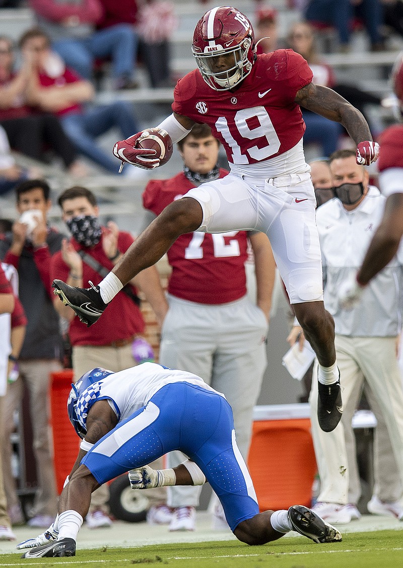 Alabama tight end Jahleel Billingsley (19) hurdles Kentucky defensive back Kelvin Joseph (1) after a catch during NCAA college football game at Bryant-Denny Stadium, Saturday, Nov. 21, 2020, in Tuscaloosa, Ala. (Mickey Welsh/The Montgomery Advertiser via AP)