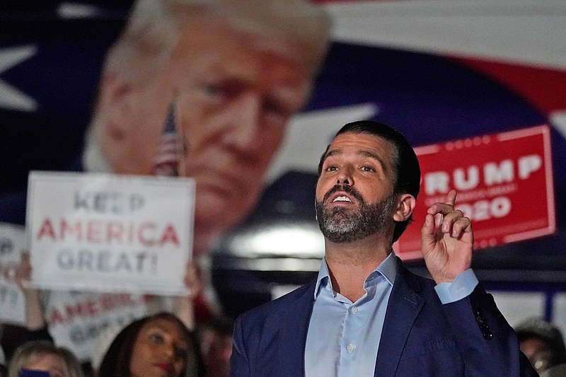 In this Nov. 5, 2020, file photo Donald Trump Jr., gestures during a news conference at Georgia Republican Party headquarters in Atlanta. A spokesman says President Donald Trump's eldest son, Donald Trump Jr., has been infected with the coronavirus.  The spokesman says the younger Trump learned his diagnosis earlier this week, has no symptoms and has been quarantining. (AP Photo/John Bazemore, File)