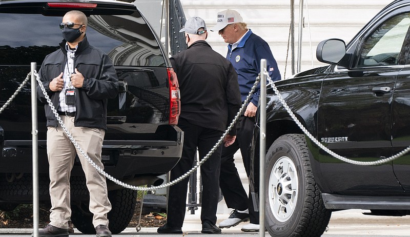 President Donald Trump, right, walks to the motorcade, Sunday, Nov. 22, 2020, as he departs the White House in Washington. (AP Photo/Jacquelyn Martin)