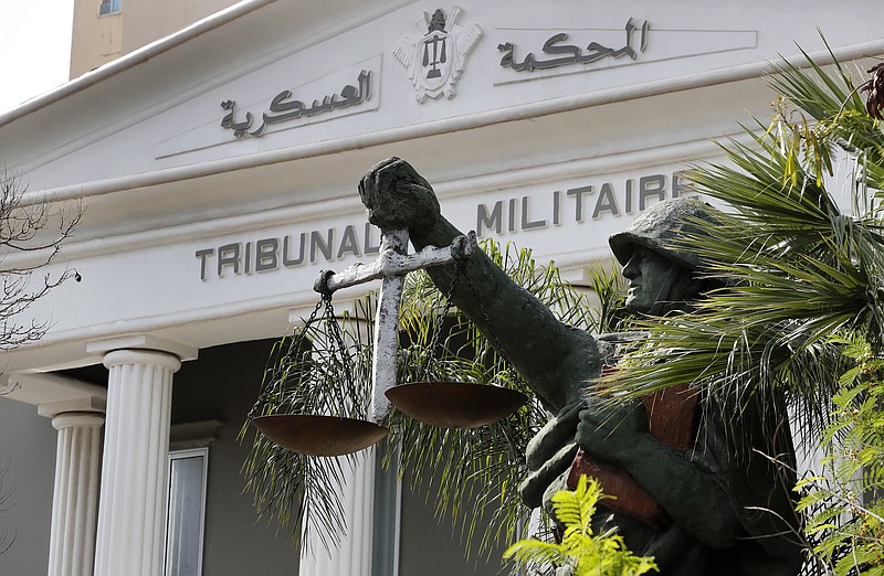 A statue of soldier carries balance, symbol of justice, is seen outside the military court in Beirut, Lebanon, Wednesday, May 27, 2020. A year after anti-government protests roiled Lebanon, dozens of protesters are being tried before military courts that human rights lawyers say grossly violate due process and fail to investigate allegations of torture and abuse. (AP Photo/Hussein Malla)
