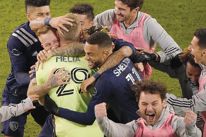 Sporting Kansas City players celebrate Sunday after winning an MLS playoff match against the San Jose Earthquakes in Kansas City, Kan.