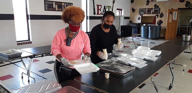 Staff photo by Junius Stone
Liberty-Eylau High School's culinary arts students give back to the community Saturday with an early Thanksgiving meal. Cars lined up early so drivers could pick up their meals and enjoy the feast at home. 
