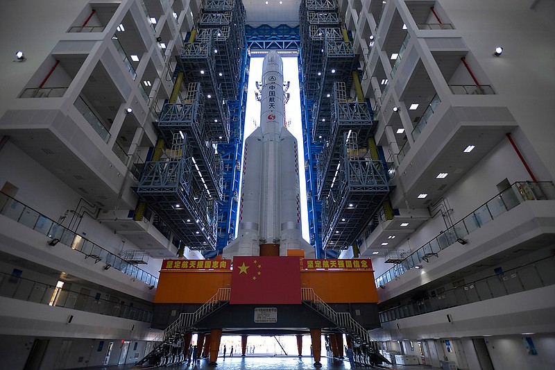 In this July 17, 2020, photo released by China's Xinhua News Agency, a Long March-5 rocket is seen at the Wenchang Space Launch Center in southern China's Hainan Province. Chinese technicians were making final preparations Monday, Nov. 23, 2020, to launch a Long March-5 rocket carrying a mission to bring back material from the lunar surface in a potentially major advance for the country's space program. (Zhang Gaoxiang/Xinhua via AP, File)