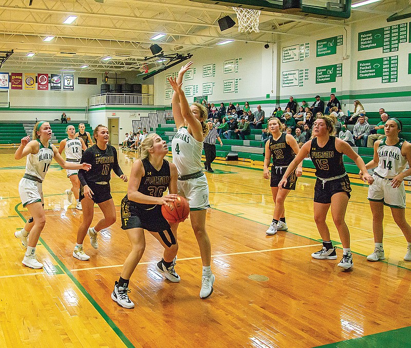 Fulton's Carly FIsher looks to take a shot in the lane as Blair Oaks' Natalie Heckman defends during the second half of Monday night's game at Wardsville.