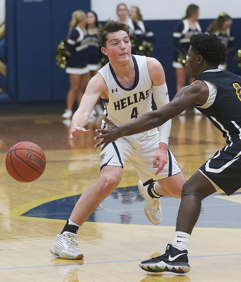 Malcolm Davis of Helias throws a bounce pass during a game last season against Soldan International at Rackers Fieldhouse.