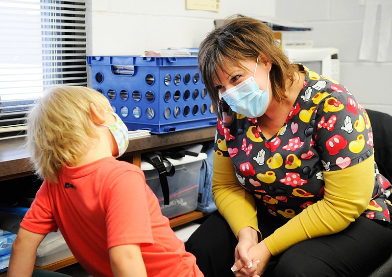 North Elementary School's nurse Donna Robinson interacts with Caleb Wegener, a student at the school.